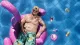 Cal liegt auf einem aufblasbaren Flamingo in einem Pool, umgeben von an der Oberfläche schwimmenden Dosen.